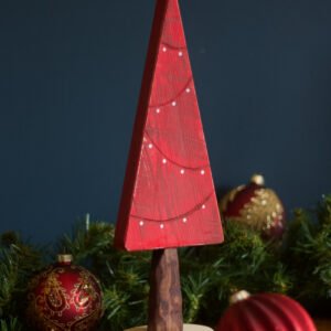 A red Christmas tree decoration featuring painted on fairy lights