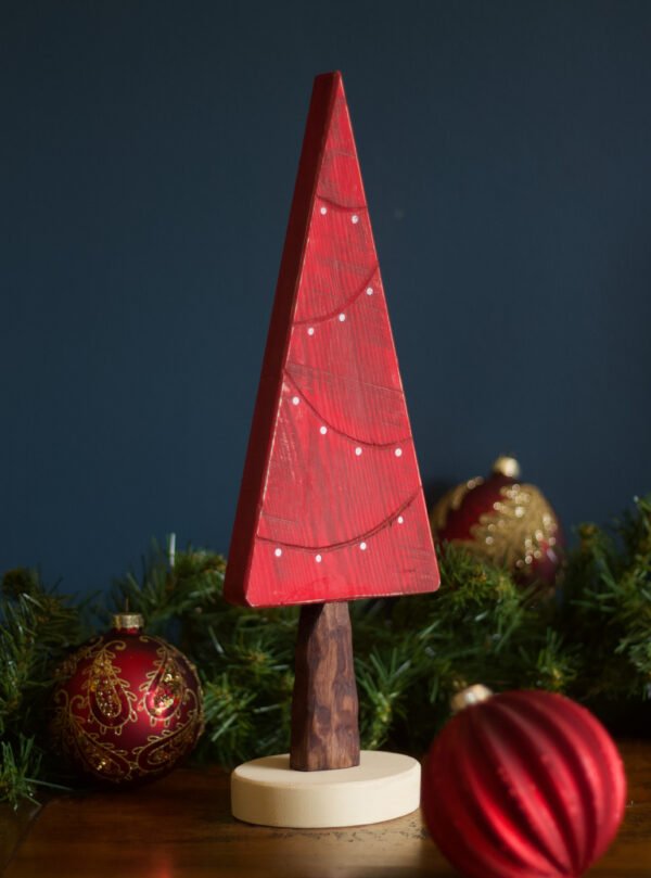 A red Christmas tree decoration featuring painted on fairy lights