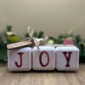 A block style christmas decoration featuring the word joy.