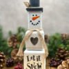 A rustic Snowman ornament made from wooden blocks