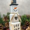 A rustic Snowman ornament made from wooden blocks