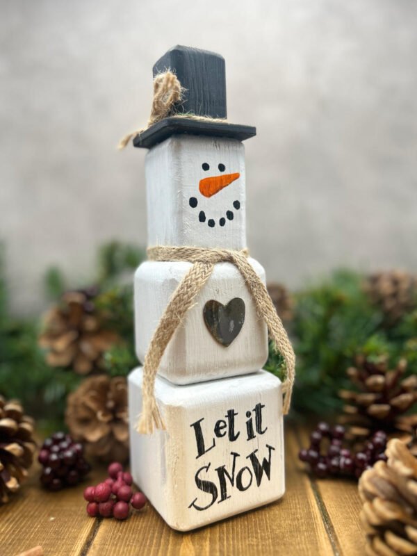 A rustic Snowman ornament made from wooden blocks