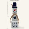 A wooden snowman decoration with dimesions.