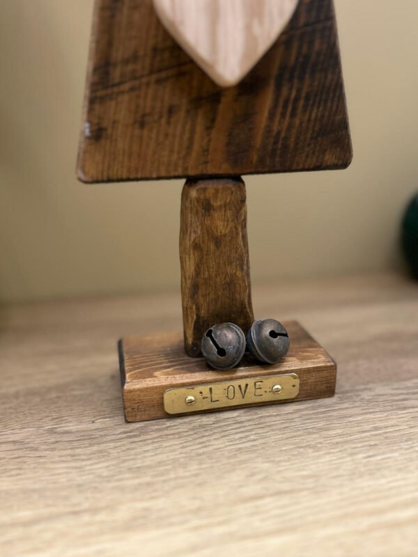 Close up details of a love themed Christmas tree ornament made from wood