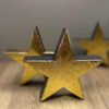 3x recycled stars made from wood with a gold leaf finish