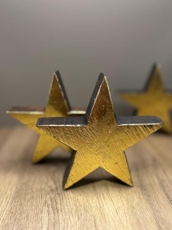 3x recycled stars made from wood with a gold leaf finish