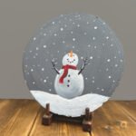 A christmas Snowman painted on a wooden slab